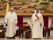 Pope Francis is greeted by Bahrain's King Hamad bin Isa Al Khalifa as he arrives at the Sakhir Royal Palace, Bahrain, Thursday, Nov. 3, 2022. Pope Francis is making the November 3-6 visit to participate in a government-sponsored conference on East-West dialogue and to minister to Bahrain's tiny Catholic community, part of his effort to pursue dialogue with the Muslim world.