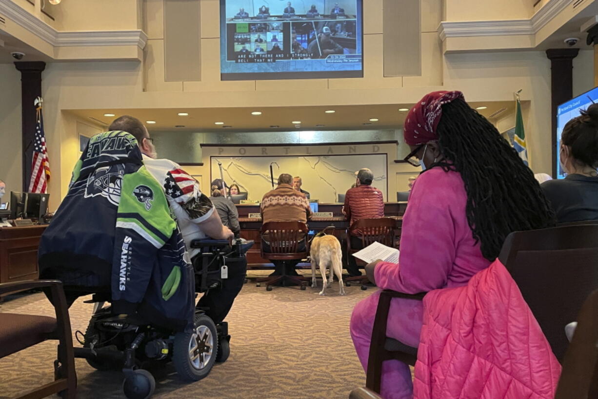 People with disabilities testify in support of a proposed ban on street camping during a city council meeting in Portland, Ore., on Oct. 26, 2022. Hundreds of Portlanders testified at the meeting, during which a resolution was introduced that would ban homeless encampments and create designated campsites sanctioned by the city. A group of people with disabilities has sued the city, saying that encampments make public sidewalks inaccessible.