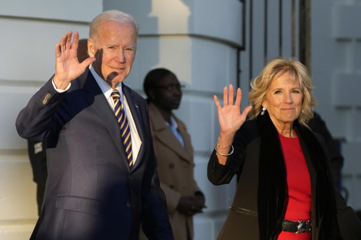 President Joe Biden and first lady Jill Biden wave as they walk to Marine One on the South Lawn of the White House, Monday, Nov. 21, 2022, in Washington. The Bidens are en route to North Carolina.