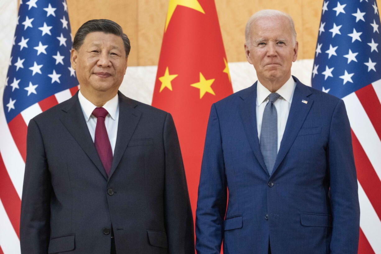 U.S. President Joe Biden, right, stands with Chinese President Xi Jinping before a meeting on the sidelines of the G20 summit meeting, Monday, Nov. 14, 2022, in Bali, Indonesia.