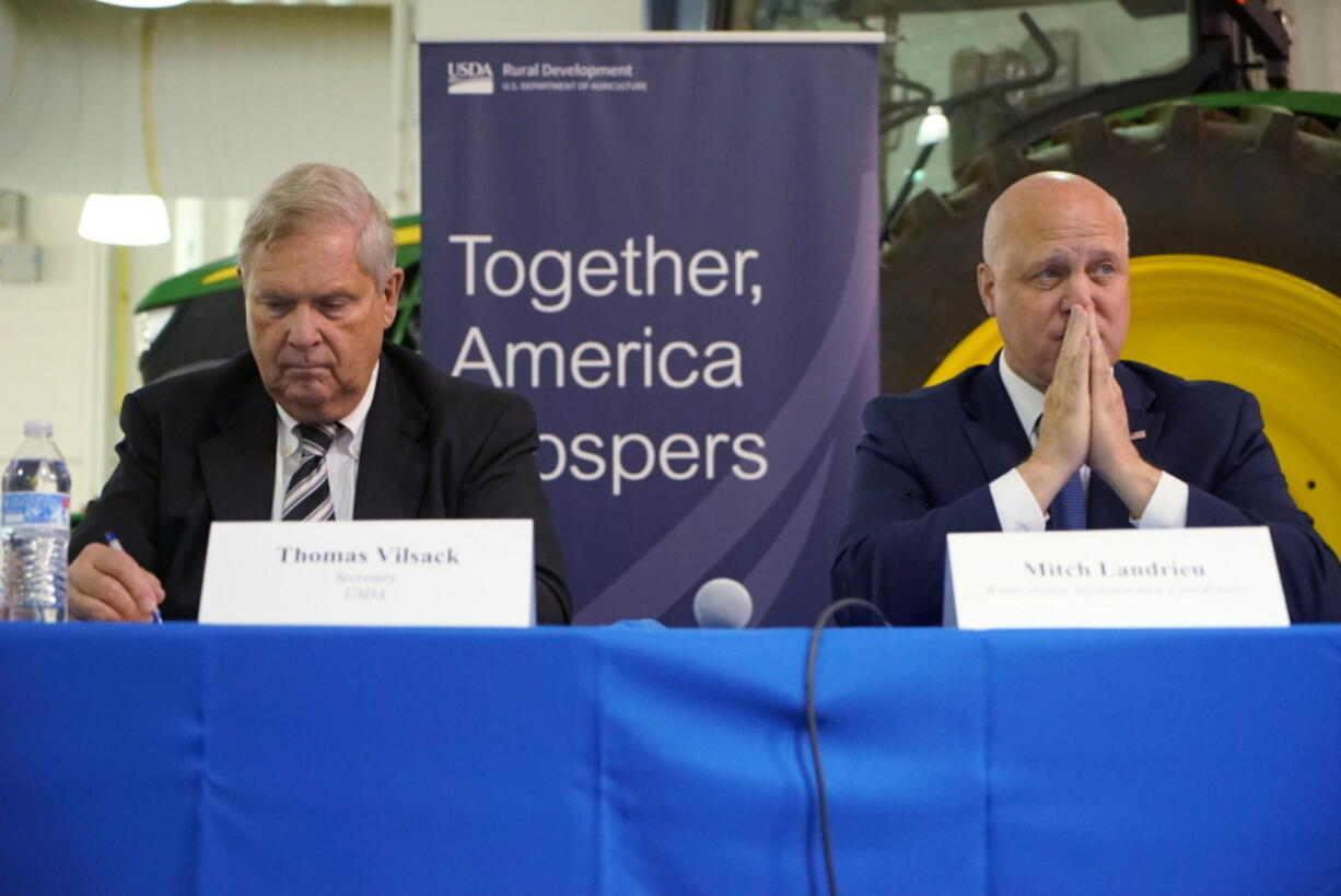 U.S. Agriculture Sec. Tom Vilsack, left, and Mitch Landrieu, White House senior adviser, listen at a community panel on rural high-speed internet at Wake Tech Community College in Raleigh, N.C., on Thursday, Oct. 27, 2022. (AP Photo/Allen G.