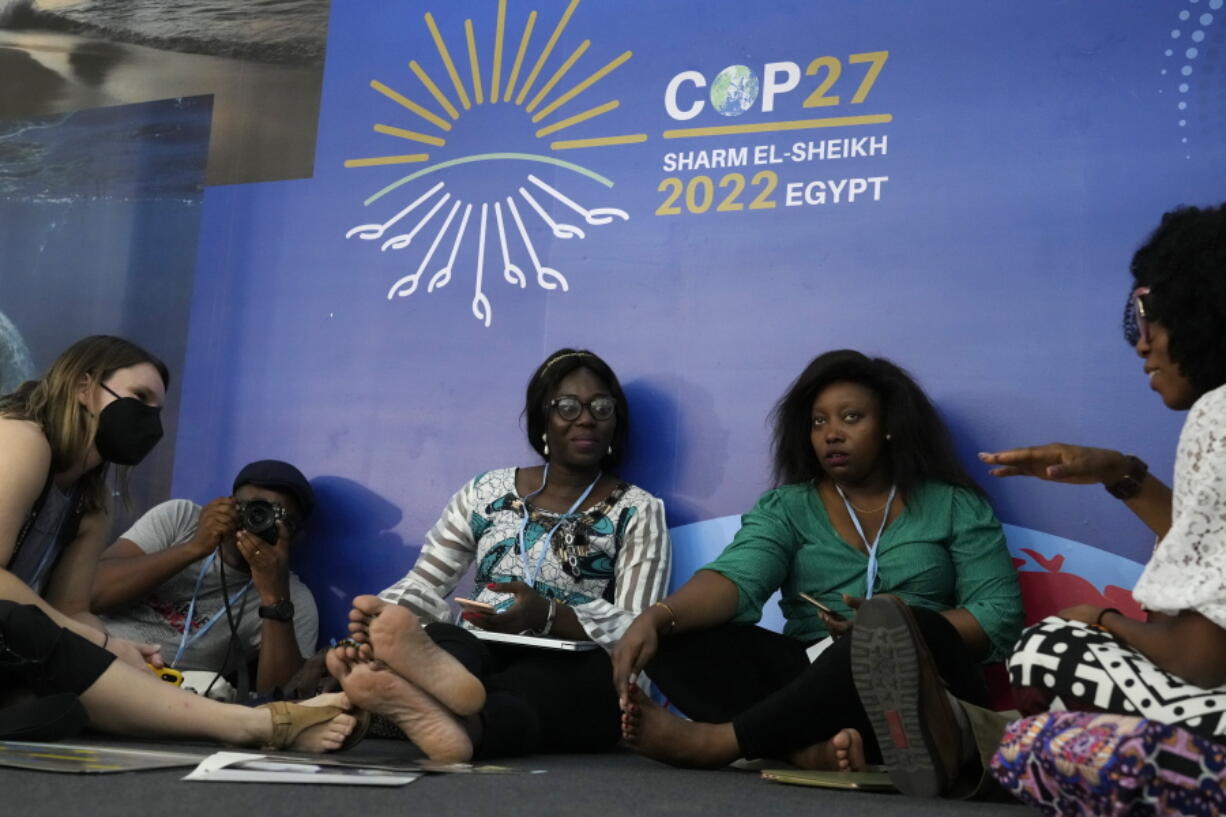 Attendees talk during the COP27 U.N. Climate Summit, Monday, Nov. 7, 2022, in Sharm el-Sheikh, Egypt.