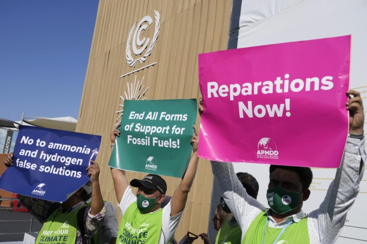 A group of demonstrators participate in an event protesting the use of fossil fuels and calling for reparations at the COP27 U.N. Climate Summit, Wednesday, Nov. 9, 2022, in Sharm el-Sheikh, Egypt.