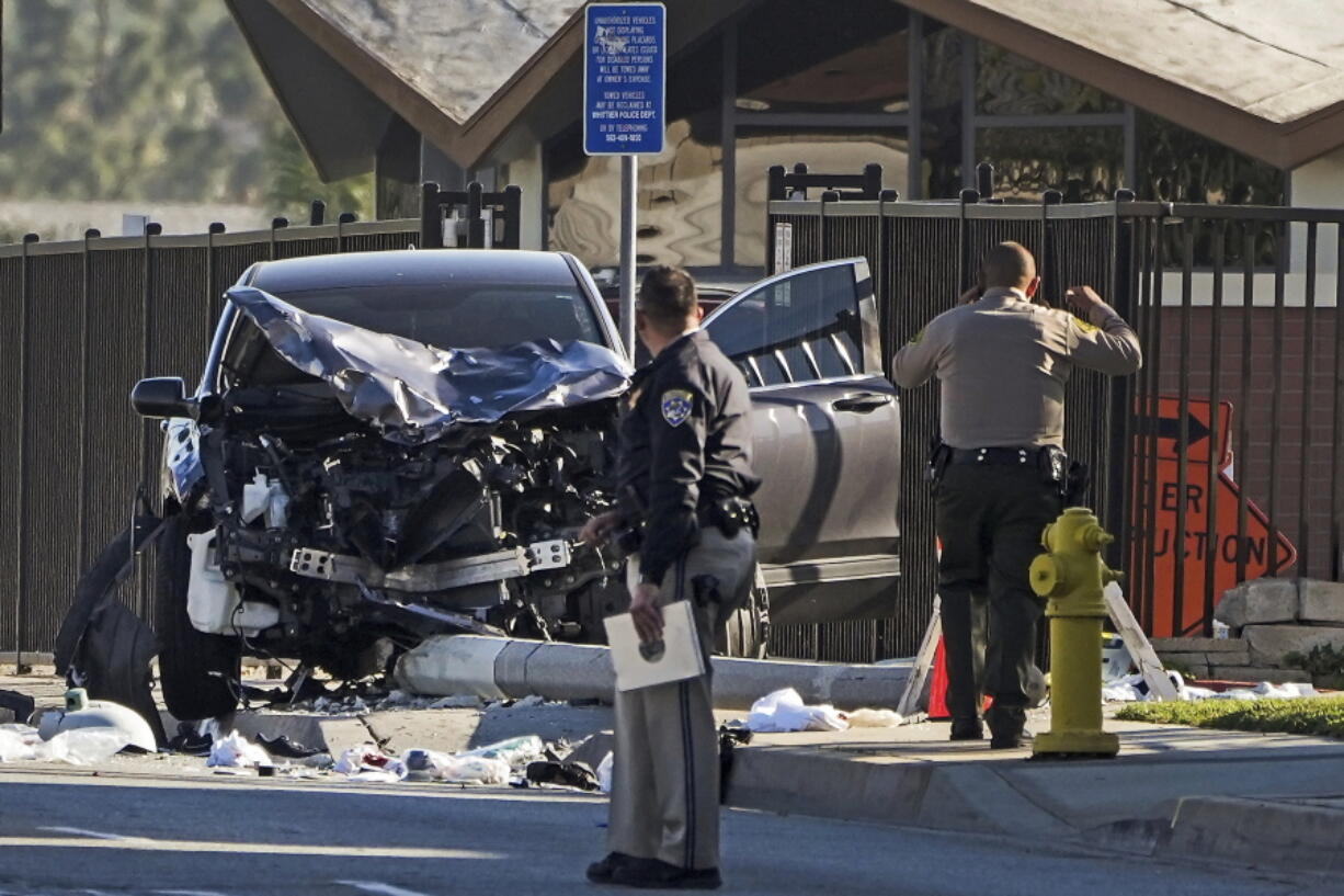 FILE - Two investigators stand next to a mangled SUV that struck Los Angeles County sheriff's recruits in Whittier, Calif., Wednesday, Nov. 16, 2022. One of the Los Angeles County law enforcement recruits struck by the SUV during a training run last week was in deteriorating condition Sunday, Nov. 20. The Los Angeles County Sheriff's Department says in a statement that Alejandro Martinez has suffered setbacks that have left him in grave condition. The department says three other members of the sheriff's academy class remain in critical condition. (AP Photo/Jae C.