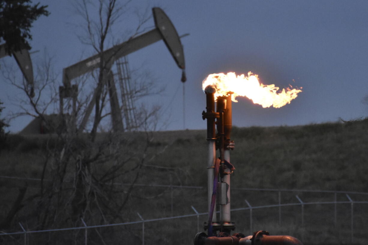 FILE - A flare to burn methane from oil production is seen on a well pad near Watford City, North Dakota, Aug. 26, 2021. The Biden administration is ramping up efforts to reduce methane emissions, targeting the oil and gas industry for its role in global warming even as President Joe Biden has pressed energy producers for more oil drilling to lower prices at the gasoline pump. Biden was set to announce a supplemental rule Friday, Nov.