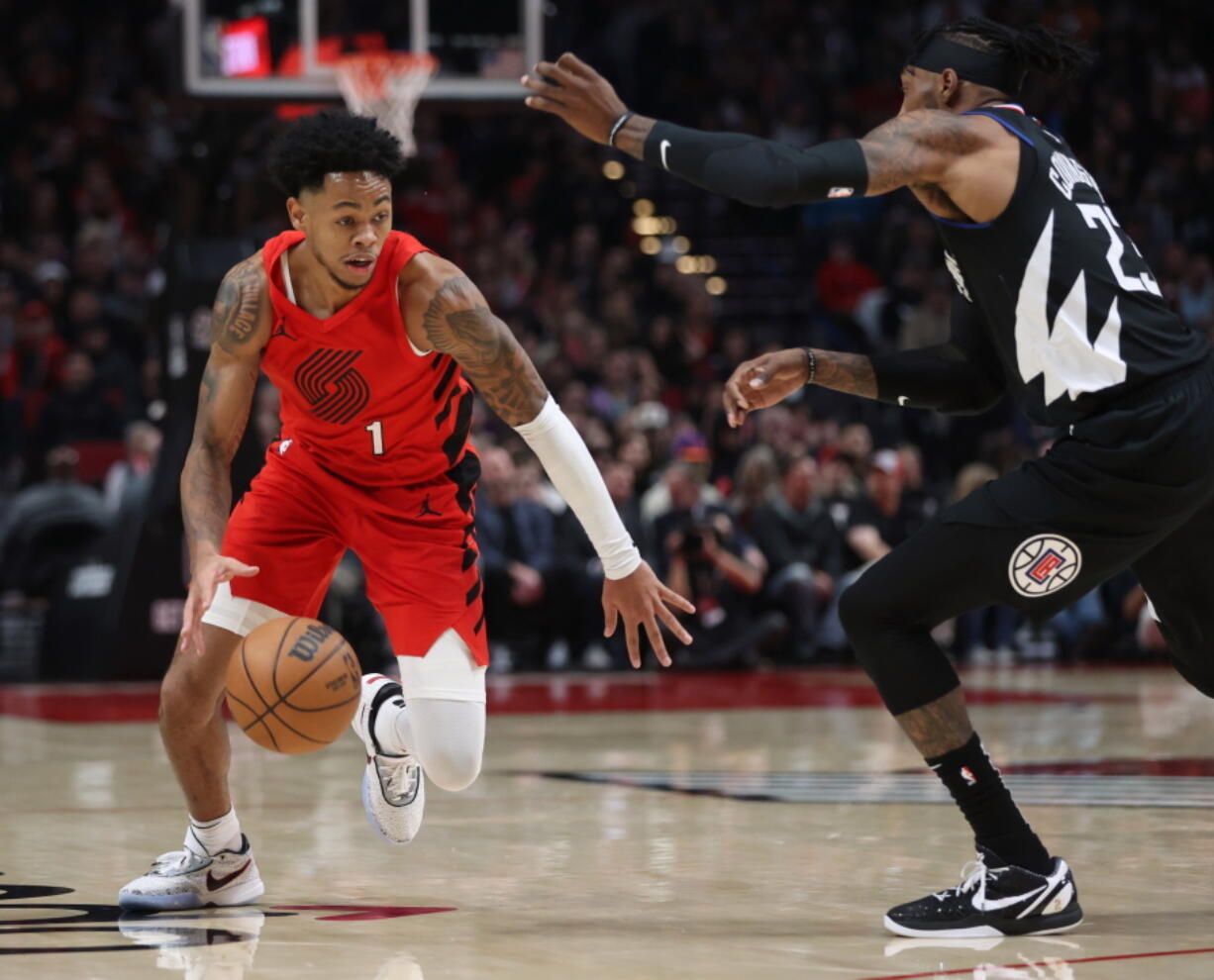 Portland Trail Blazers guard Anfernee Simons, left, drives against Los Angeles Clippers forward Robert Covington during the first half of an NBA basketball game in Portland, Ore., Tuesday, Nov. 29, 2022.