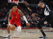 Portland Trail Blazers guard Anfernee Simons, left, drives against Los Angeles Clippers forward Robert Covington during the first half of an NBA basketball game in Portland, Ore., Tuesday, Nov. 29, 2022.