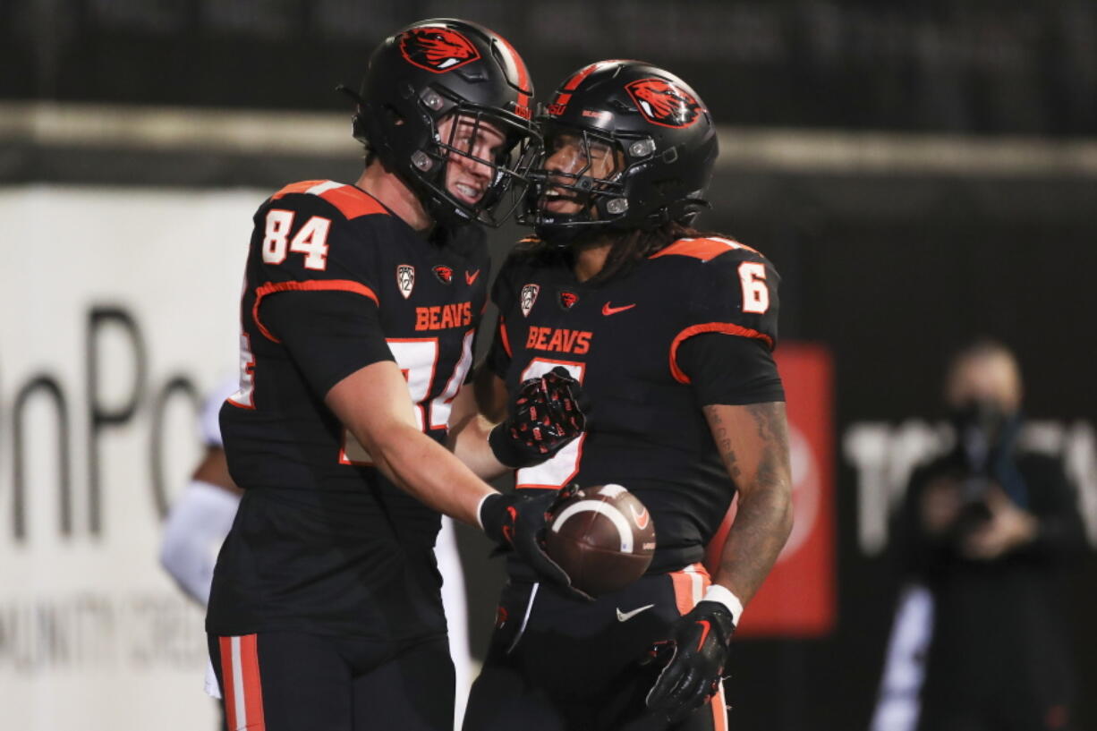 Oregon State tight end Jack Velling (84) celebrates after scoring a touchdown against Colorado with teammate Damien Martinez during the second half of an NCAA college football game on Saturday, Oct. 22, 2022, in Corvallis, Ore.