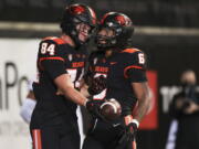 Oregon State tight end Jack Velling (84) celebrates after scoring a touchdown against Colorado with teammate Damien Martinez during the second half of an NCAA college football game on Saturday, Oct. 22, 2022, in Corvallis, Ore.