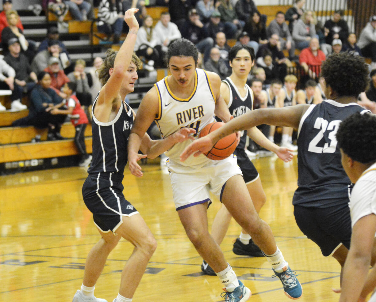 Columbia River’s Niko Valdez (24) drives against Matthew Belefski of King’s Way Christian (left) during King’s Way’s 54-44 win over the Rapids at Columbia River High School on Wednesday, Nov. 30, 2022.