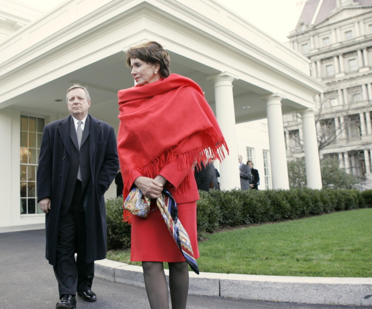 FILE - House Speaker Nancy Pelosi of Calif., right, and Senate Majority Whip Richard Durbin of Ill., walk out of the West Wing of the White House in Washington, Jan. 10, 2007, toward reporters following a meeting with President Bush to discuss his revised Iraq strategy.