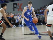 Duke center Kyle Filipowski, right, dribbles towards Oregon State forward Michael Rataj during the first half of an NCAA college basketball game in the Phil Knight Legacy tournament in Portland, Ore., Thursday, Nov. 24, 2022.