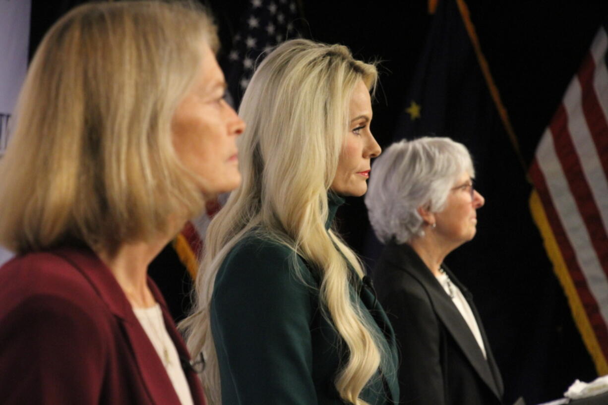 Republican Kelly Tshibaka, center, a Republican, looks on Thursday, Oct. 27, 2022, prior to a U.S. Senate debate in Anchorage, Alaska. She faces U.S. Sen. Lisa Murkowski, left, and Democrat Pat Chesbro, right, in the general election.