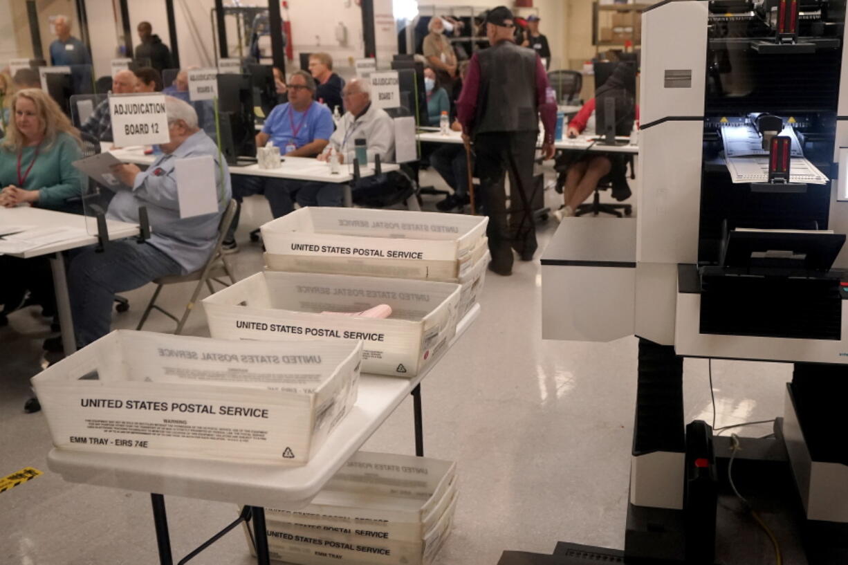 Adjudicators observe as ballots are tabulated inside the Maricopa County Recorders Office, Wednesday, Nov. 9, 2022, in Phoenix.