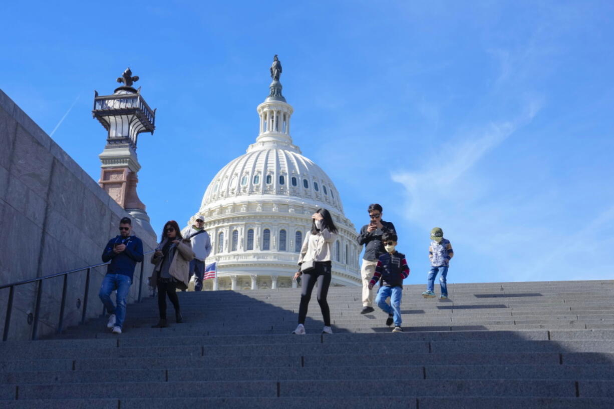 With the U.S Capitol in the background, people walk down steps on Election Day in Washington, Tuesday, Nov. 8, 2022.