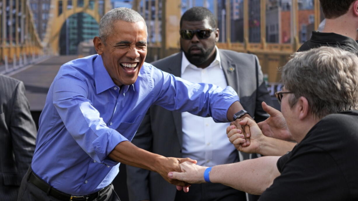 Former President Barrack Obama, left, is introduced during a campaign rally in support of Pennsylvania Lt. Gov. John Fetterman, a Democratic candidate for U.S. Senate, in Pittsburgh, Saturday, Nov. 5, 2022. (AP Photo/Gene J.