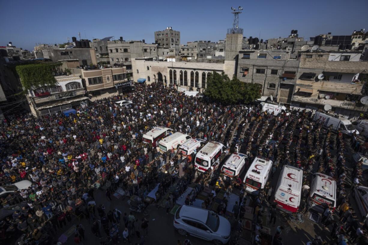 FILE - Mourners pray for members of the Palestinian Abu Raya family that died in a fire in their apartment building in the Jebaliya refugee camp, northern Gaza Strip, Friday, Nov. 18, 2022. A house fire that killed 22 Palestinians from one family who gathered this week for a celebration was caused when a family member used gasoline during a stunt show before losing control, Gaza's Hamas authorities said Sunday.