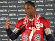 Seattle Seahawks quarterback Geno Smith wears a FC Bayern Munich scarf as he answers questions during a news conference after a practice session in Munich, Germany, Thursday, Nov. 10, 2022. The Tampa Bay Buccaneers are set to play the Seattle Seahawks in an NFL game at the Allianz Arena in Munich on Sunday.