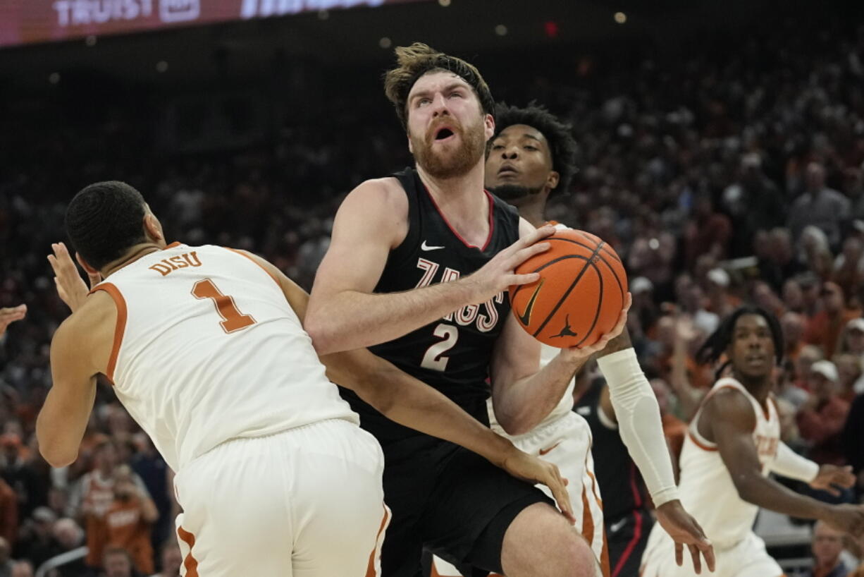 Gonzaga forward Drew Timme (2) drives to the basket against Texas forward Dylan Disu (1) during the first half of an NCAA college basketball game, Wednesday, Nov. 16, 2022, in Austin, Texas.