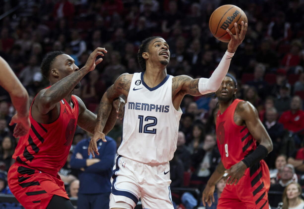 Memphis Grizzlies guard Ja Morant shoots in front of Portland Trail Blazers forward Nassir Little, left, during the second half of an NBA basketball game in Portland, Ore., Wednesday, Nov. 2, 2022.