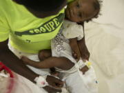 A baby stricken with cholera receives treatment at a clinic run by Doctors Without Borders in Port-au-Prince, Haiti, Friday, Nov. 11, 2022.