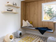 This image released by Anna Popov shows a spare room that was converted to a reading room with climbing shelves and cubbies for cats to enjoy in Redmond, Wash., designed by Anna Popov.