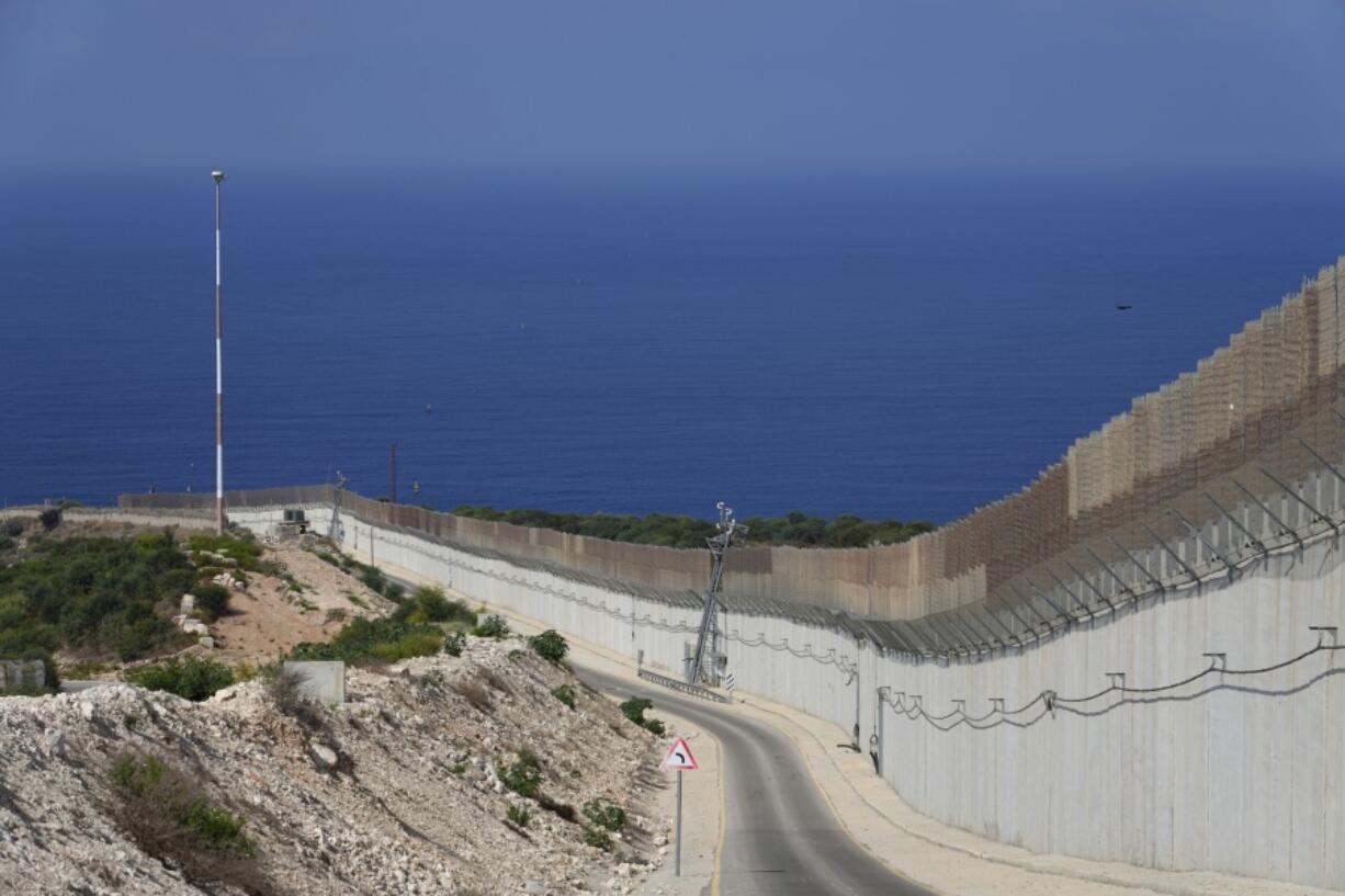 FILE - The border wall runs between Israel and Lebanon with the Mediterranean Sea in the distance, in Rosh Hanikra, Israel, on Oct. 14, 2022.