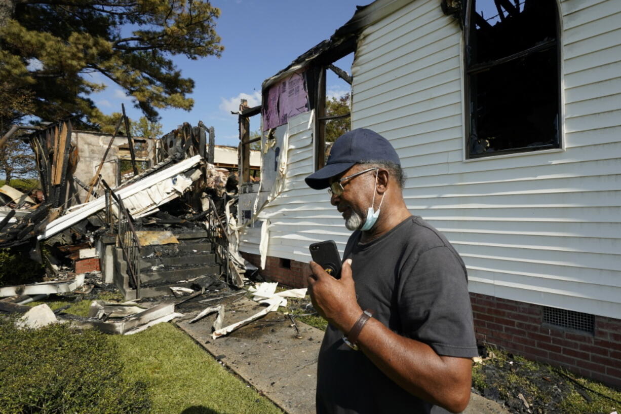 Elder Lloyd Caston, 73, walks around the remains Epiphany Lutheran Church near mid-town Jackson, Miss., Tuesday, Nov. 8, 2022. Authorities in Mississippi's capital city are on the hunt for a suspected arsonist who set several fires early Tuesday morning on and near the campus of Jackson State University, a historically Black public university. At least two of the buildings set ablaze were churches. (AP Photo/Rogelio V.