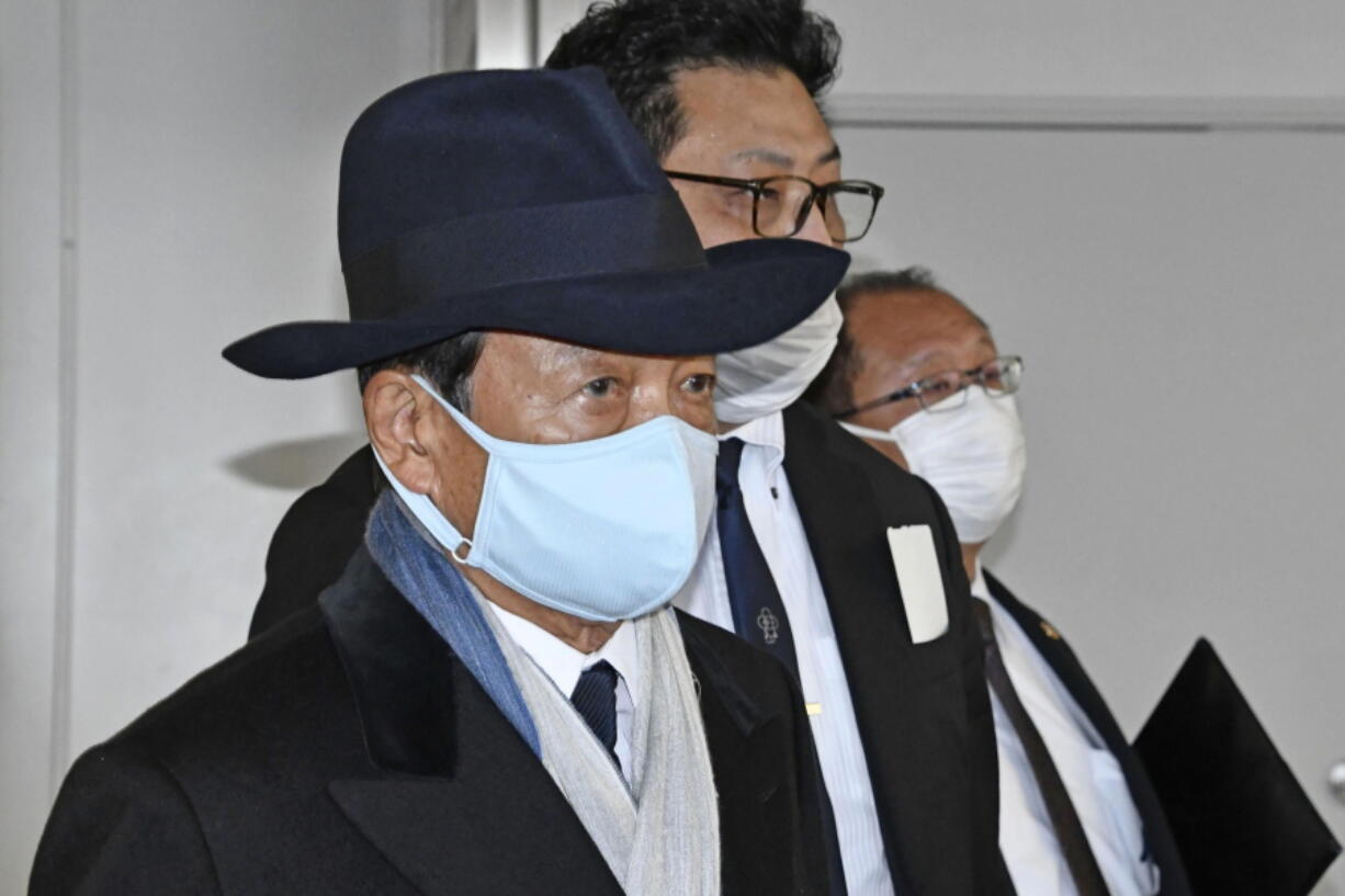 Former Japanese Prime Minister Taro Aso walks towards his flight at Narita International Airport in Narita, near Tokyo Wednesday, Nov. 2, 2022, on his way to South Korea. Aso left for Seoul on Wednesday to meet with South Korean officials as the two countries try to improve ties badly strained by Japanese wartime atrocities.