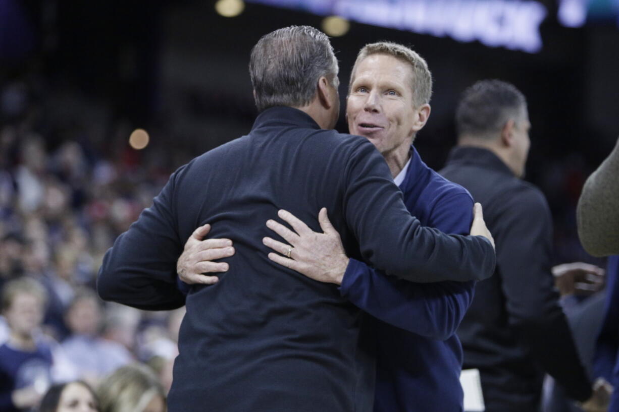 Gonzaga head coach Mark Few, right, and Kentucky head coach John Calipari greet each other before an NCAA college basketball game, Sunday, Nov. 20, 2022, in Spokane, Wash.