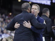 Gonzaga head coach Mark Few, right, and Kentucky head coach John Calipari greet each other before an NCAA college basketball game, Sunday, Nov. 20, 2022, in Spokane, Wash.