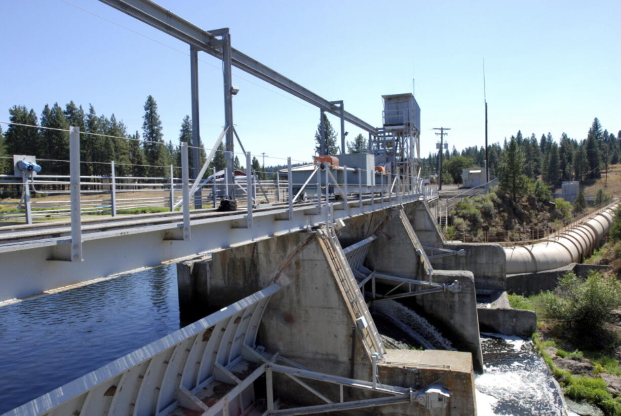 FILE - The J.C. Boyle Dam diverts water from the Klamath River to a powerhouse downstream on Aug. 21, 2009, in Keno, Ore. Plans for the largest dam demolition project in U.S. history to save imperiled salmon could soon become reality, with the first stages of construction starting in California as early as this summer. The Federal Energy Regulatory Commission meets Thursday, Nov. 17, 2022, and is expected to vote on whether to approve the surrender of PacificCorp's hydroelectric license for four dams on the lower Klamath River in remote northern California.