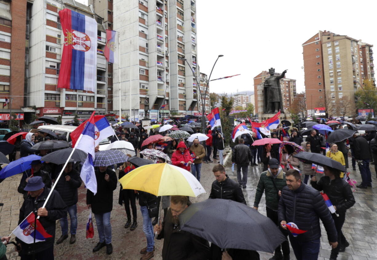 Kosovo Serbs wave Serbian flags during a protest in Mitrovica, Kosovo, Sunday, Nov. 6, 2022. Several thousand ethnic Serbs on Sunday rallied in Kosovo after a dispute over vehicle license plates triggered a Serb walkout from their jobs in Kosovo's institutions and heightened ongoing tensions stemming from a 1990s' conflict.