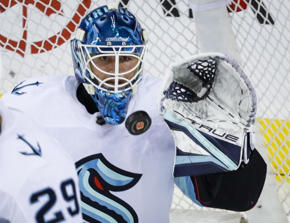 Seattle Kraken goalie Joey Daccord stops a shot during the second period of an NHL hockey game against the Calgary Flames, Tuesday, Nov. 1, 2022 in Calgary, Alberta.