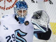 Seattle Kraken goalie Joey Daccord stops a shot during the second period of an NHL hockey game against the Calgary Flames, Tuesday, Nov. 1, 2022 in Calgary, Alberta.