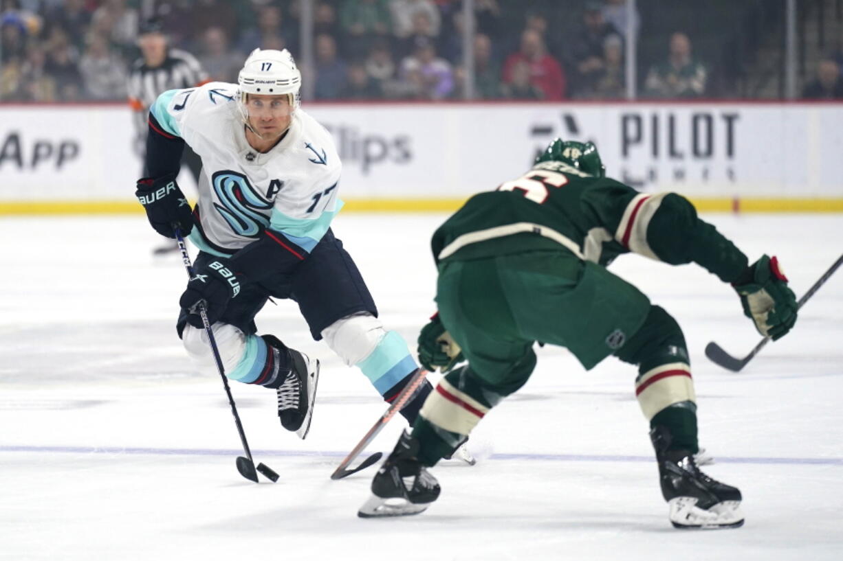 Seattle Kraken center Jaden Schwartz (17) skates with the puck against Minnesota Wild defenseman Jared Spurgeon (46) during the first period of an NHL hockey game Thursday, Nov. 3, 2022, in St. Paul, Minn.