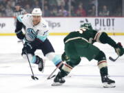 Seattle Kraken center Jaden Schwartz (17) skates with the puck against Minnesota Wild defenseman Jared Spurgeon (46) during the first period of an NHL hockey game Thursday, Nov. 3, 2022, in St. Paul, Minn.