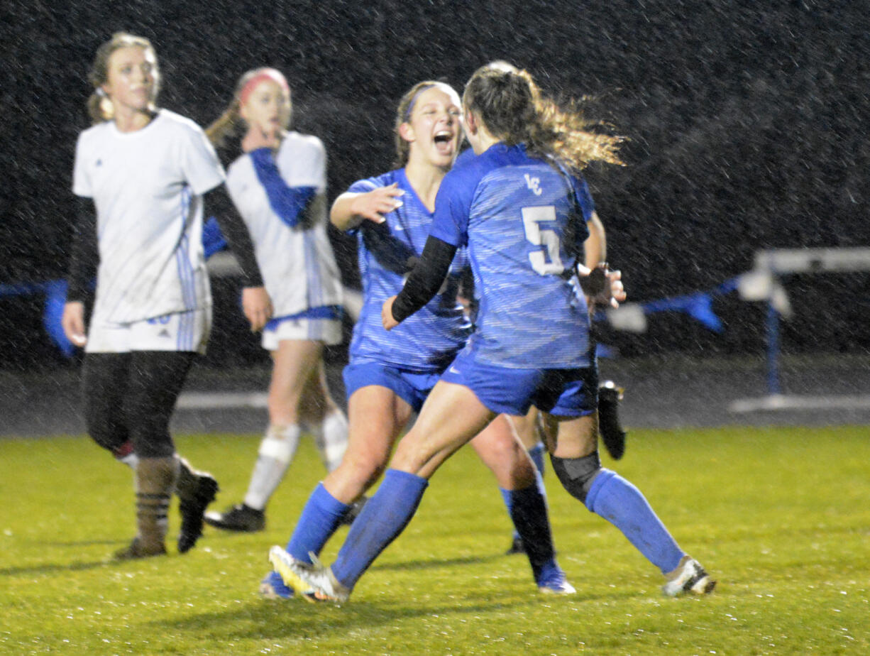 La Center's Sadie Pratt celebrates with teammate Shaela Bradley (5) after Bradley scored during the 1A district semifinal soccer match at La Center High School on Thursday, Nov. 3, 2022.