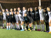 Mountain View players pose for a photo after defeating Kelso 2-0 in the 3A bi-district girls soccer game on Nov. 3, 2022, at District Stadium in Battle Ground.