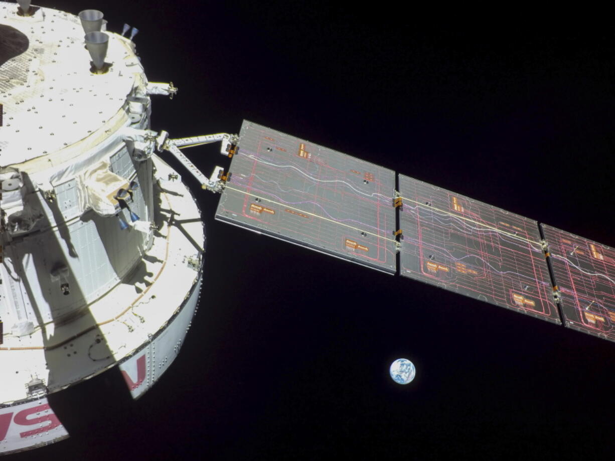 This image provided by NASA shows flight Day 9 imagery that NASA's Orion spacecraft captured looking back at the Earth from a camera mounted on one of its solar arrays. NASA's Orion capsule is now circling the moon in an orbit stretching tens of thousands of miles. The capsule and its three test dummies entered the far-flung orbit Friday, Nov. 25, 2022, more than a week after launching on the test flight.