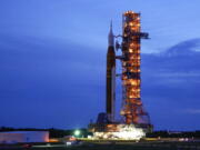 FILE - The NASA moon rocket slated for the Artemis mission to the moon rolls back to the Vehicle Assembly Building at the Kennedy Space Center Tuesday, Sept. 27, 2022, in Cape Canaveral, Fla. On Tuesday, Nov. 8, 2022, NASA announced it is again postponing the launch of its new moon rocket because of a storm threatening the Florida coast. NASA was aiming for a launch attempt this weekend -- just after midnight on Sunday.