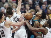 Portland Trail Blazers guard Anfernee Simons, second from right, is stopped by Brooklyn Nets forward Kevin Durant, right, forward Joe Harris, second from left, and guard Ben Simmons during the second half of an NBA basketball game in Portland, Ore., Thursday, Nov. 17, 2022.