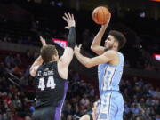 North Carolina forward Pete Nance, right, shoots over Portland center Joey St. Pierre during the first half of an NCAA college basketball game in the Phil Knight Invitational tournament in Portland, Ore., Thursday, Nov. 24, 2022.