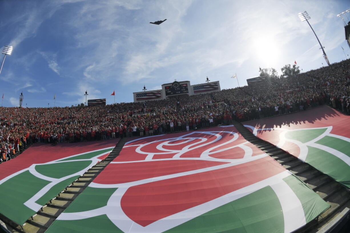 The Rose Bowl logo is seen during a fly over before the Rose Bowl NCAA college football game between Utah and Ohio State Saturday, Jan. 1, 2022, in Pasadena, Calif. Flipping the current college football playoff from four-teams to a 12-teams for the final two years of the current television contract will give those in charge of the postseason a look at how it works before committing to anything long term. But, The Granddaddy of Them All wants the CFP management committee to assure game organizers that their game will continue to be played annually on New Year's Day.  (AP Photo/Mark J.