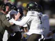 Oregon head coach Dan Lanning, left, congratulates Noah Sewell after he rushed for a 1-yard touchdown against Colorado in the first half of an NCAA college football game, Saturday, Nov. 5, 2022, in Boulder, Colo.