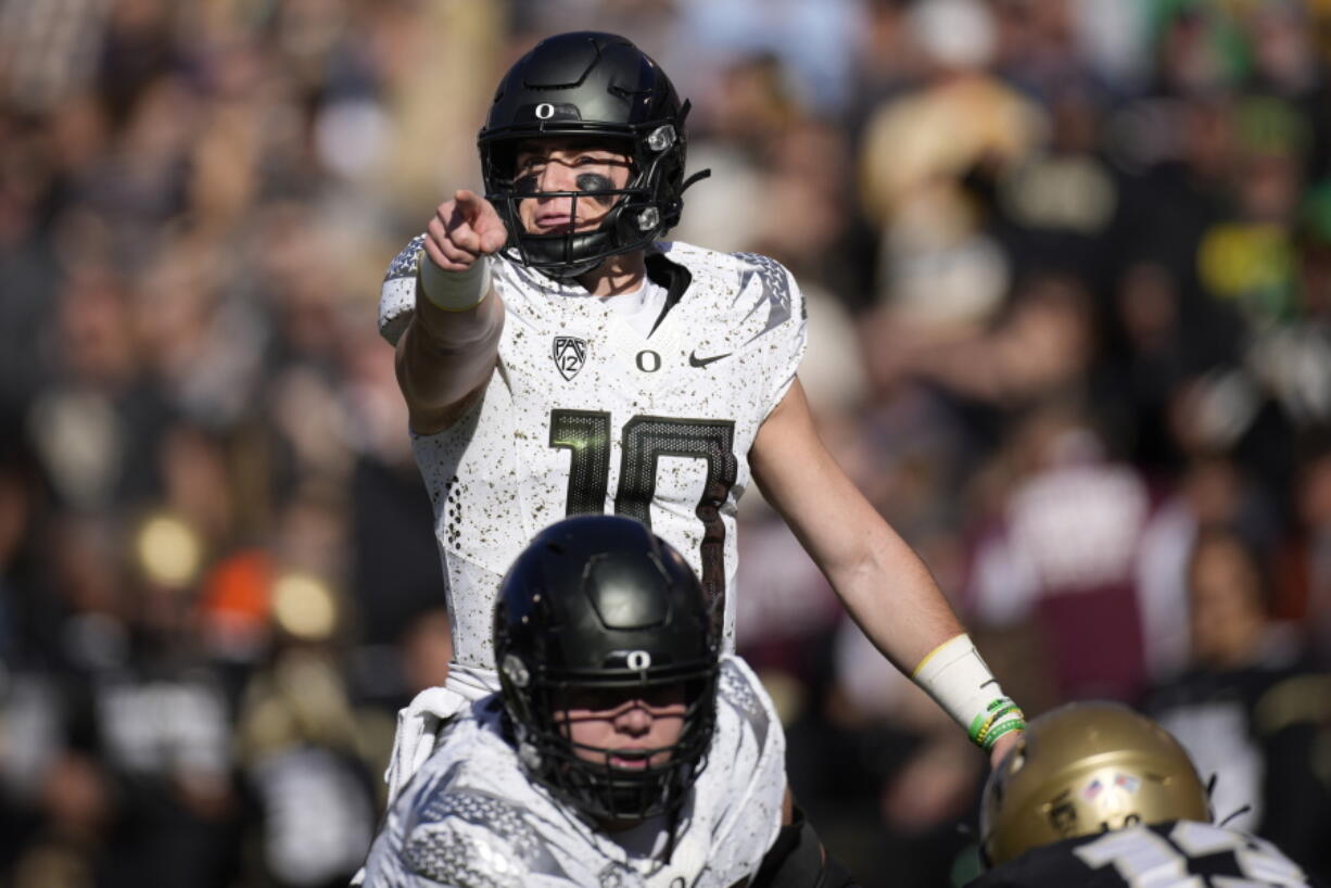 Oregon quarterback Bo Nix directs players at the line of scrimmage against Colorado in the first half of an NCAA college football game, Saturday, Nov. 5, 2022, in Boulder, Colo.