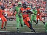 Oregon State running back Isaiah Newell (25) scores a touchdown against Oregon during the second half of an NCAA college football game on Saturday, Nov 26, 2022, in Corvallis, Ore.