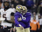 Washington placeholder Jack McCallister (38), right, congratulates place kicker Peyton Henry (47) kicking a field goal with eight seconds left on the clock against Oregon State during the second half of an NCAA collage football game, Friday, Nov. 4, 2022, in Seattle. Washington won 24-21.