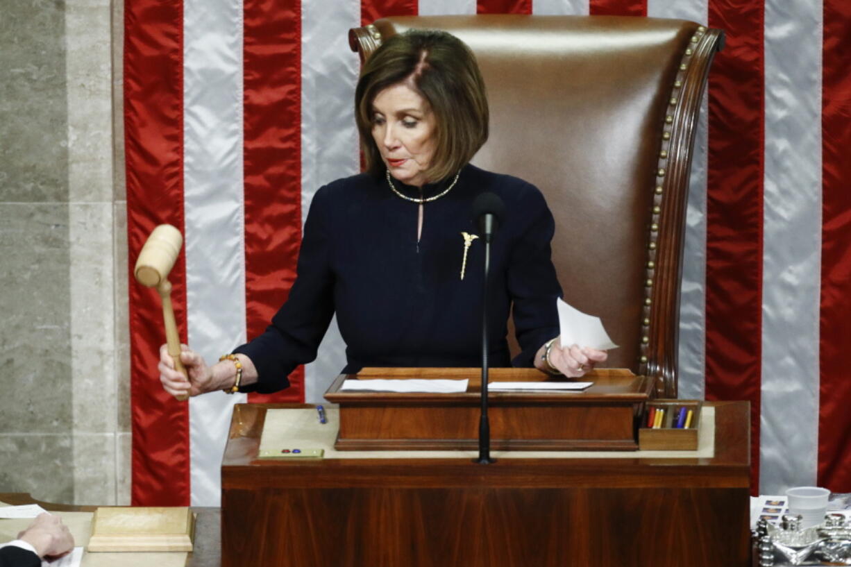 FILE - House Speaker Nancy Pelosi of Calif., strikes the gavel after announcing the passage of article II of impeachment against President Donald Trump, Dec. 18, 2019, on Capitol Hill in Washington.