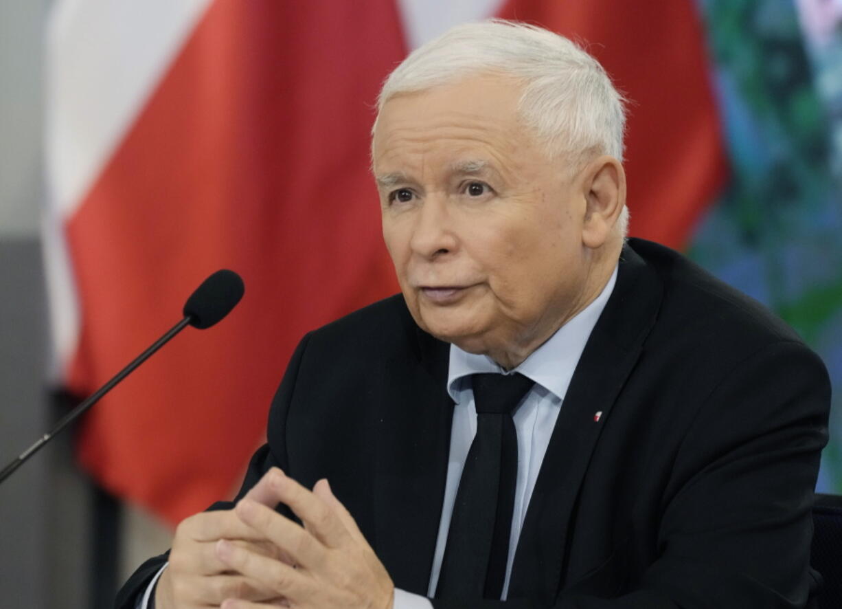 FILE -Jaroslaw Kaczynski, the leader of Poland's ruling Law and Justice party gives Prime Minister Beata Szydlo a kiss and a bunch of flowers after her government survived a vote in which the opposition was seeking to oust it, at the parliament building in Warsaw, Poland, Thursday, Dec. 7, 2017. Poland's ruling party leader has triggered anger and mockery by claiming that the country's low birthrate is partly caused by overconsumption of alcohol by young women. Opposition politicians and many other critics accused Jaroslaw Kaczynski, a 73-year-old lifelong bachelor, of being out of touch.